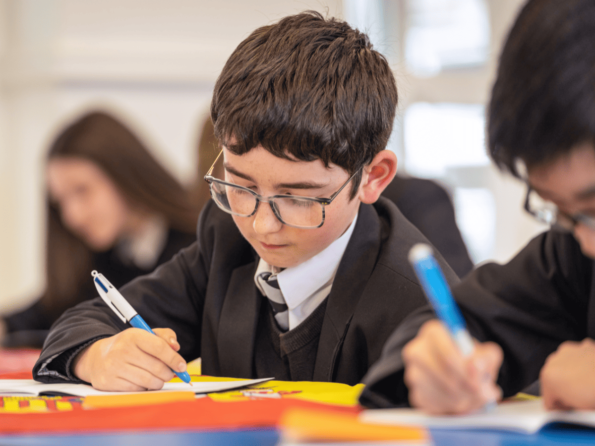 A student from Cheadle Hulme High School takes notes in a Spanish class. Featured: NCLE CHHS becomes a lead Language Hub school