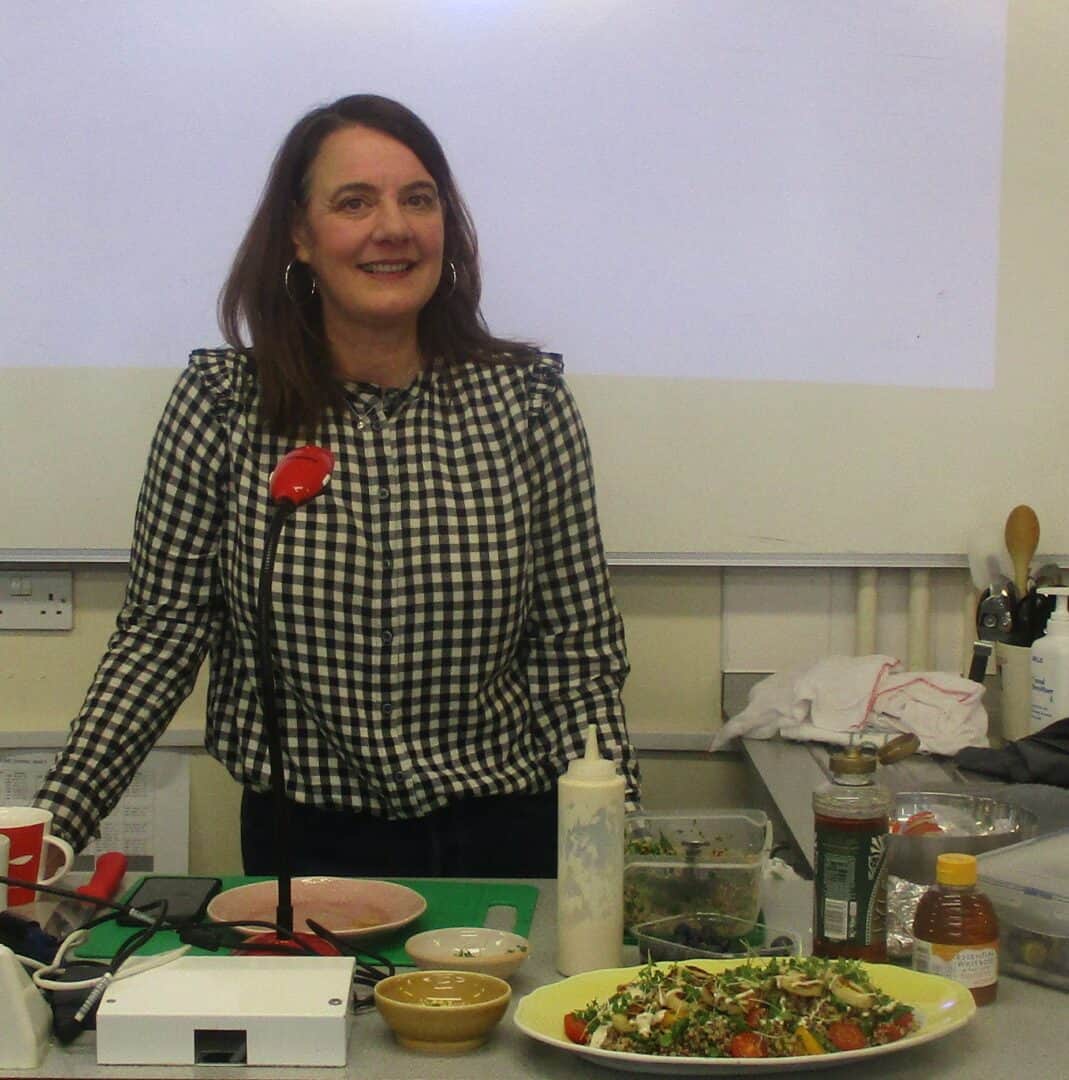 Food stylist smiles with her stylish dishes