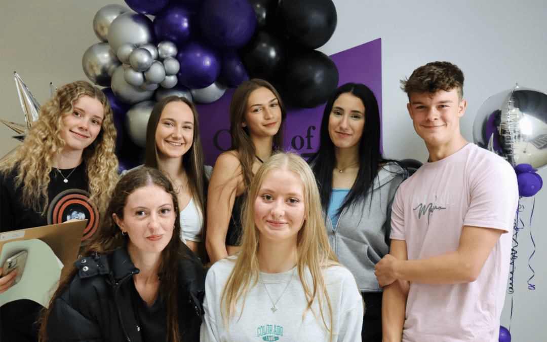 Cheadle Hulme High School students stand smiling as they celebrate their GCSE results.