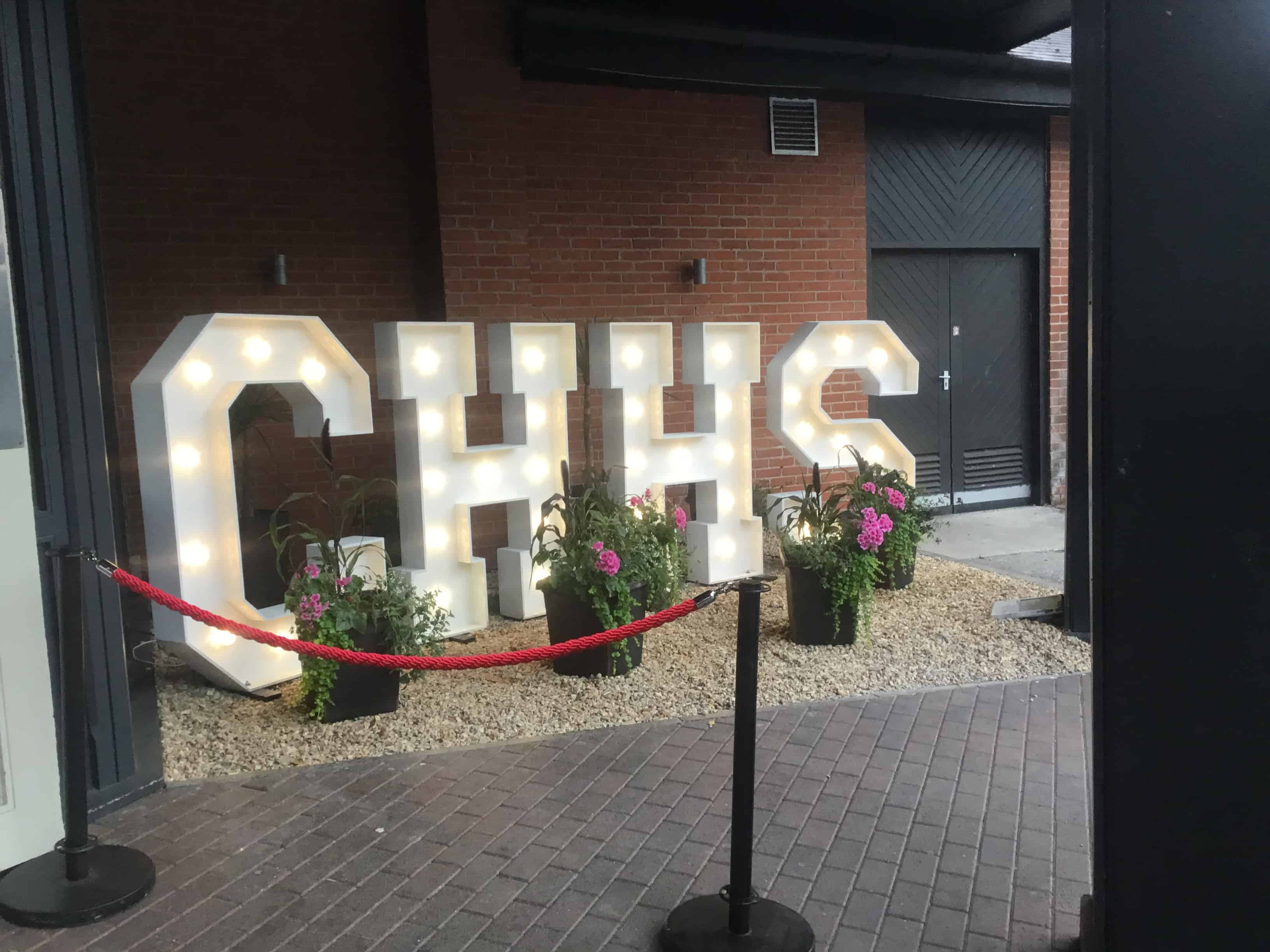 Cheadle Hulme High School Prom 2023 light sign with the letters CHHS.