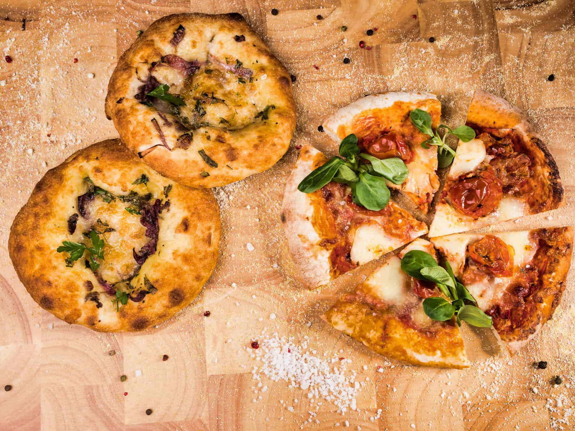 An example of food available in Cheadle Hulme High School canteen. Prepared by Dolce, pastries and pizza against a wooden background.