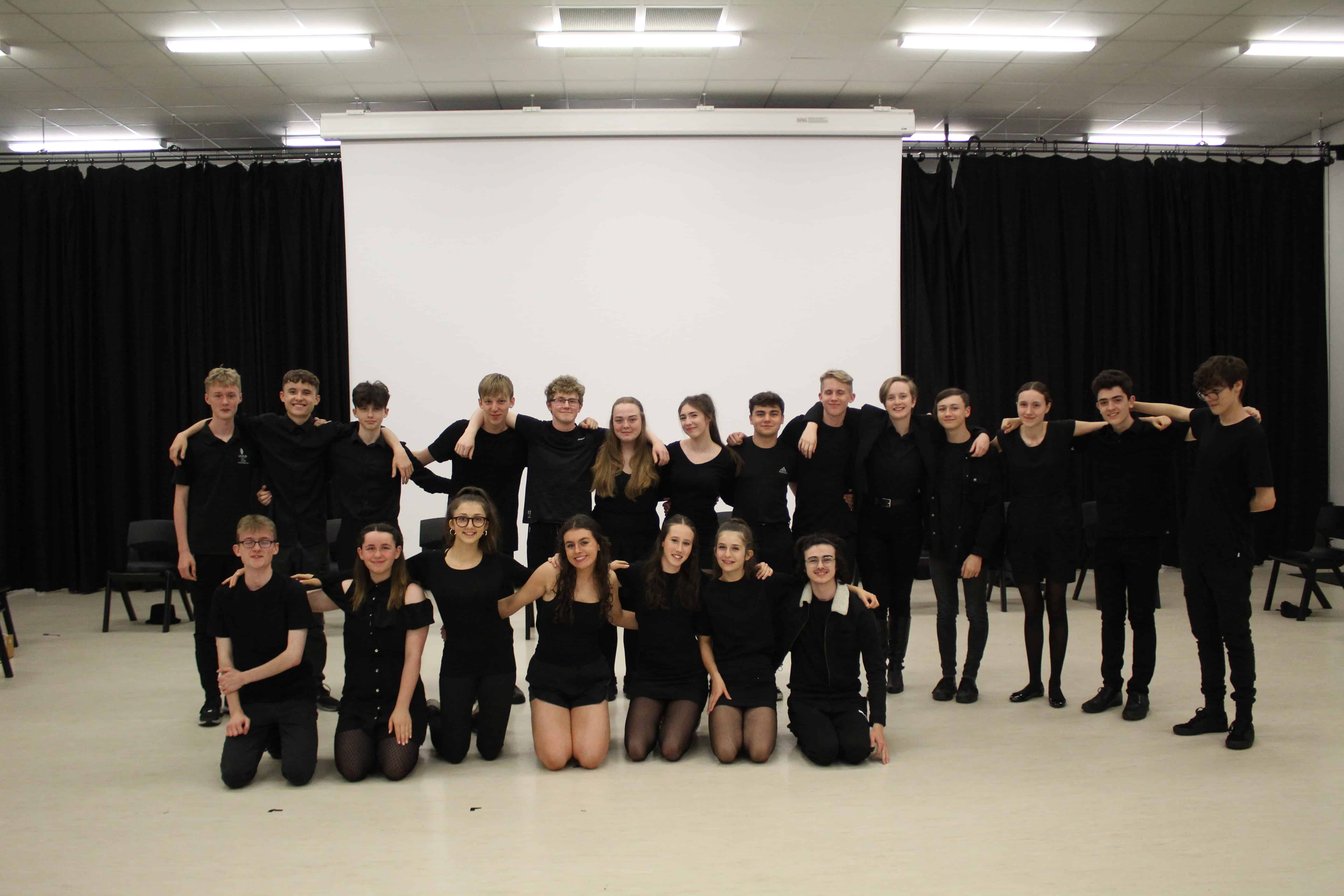 The students involved in Laurus Limelights smile together as a group at Cheadle Hulme High School