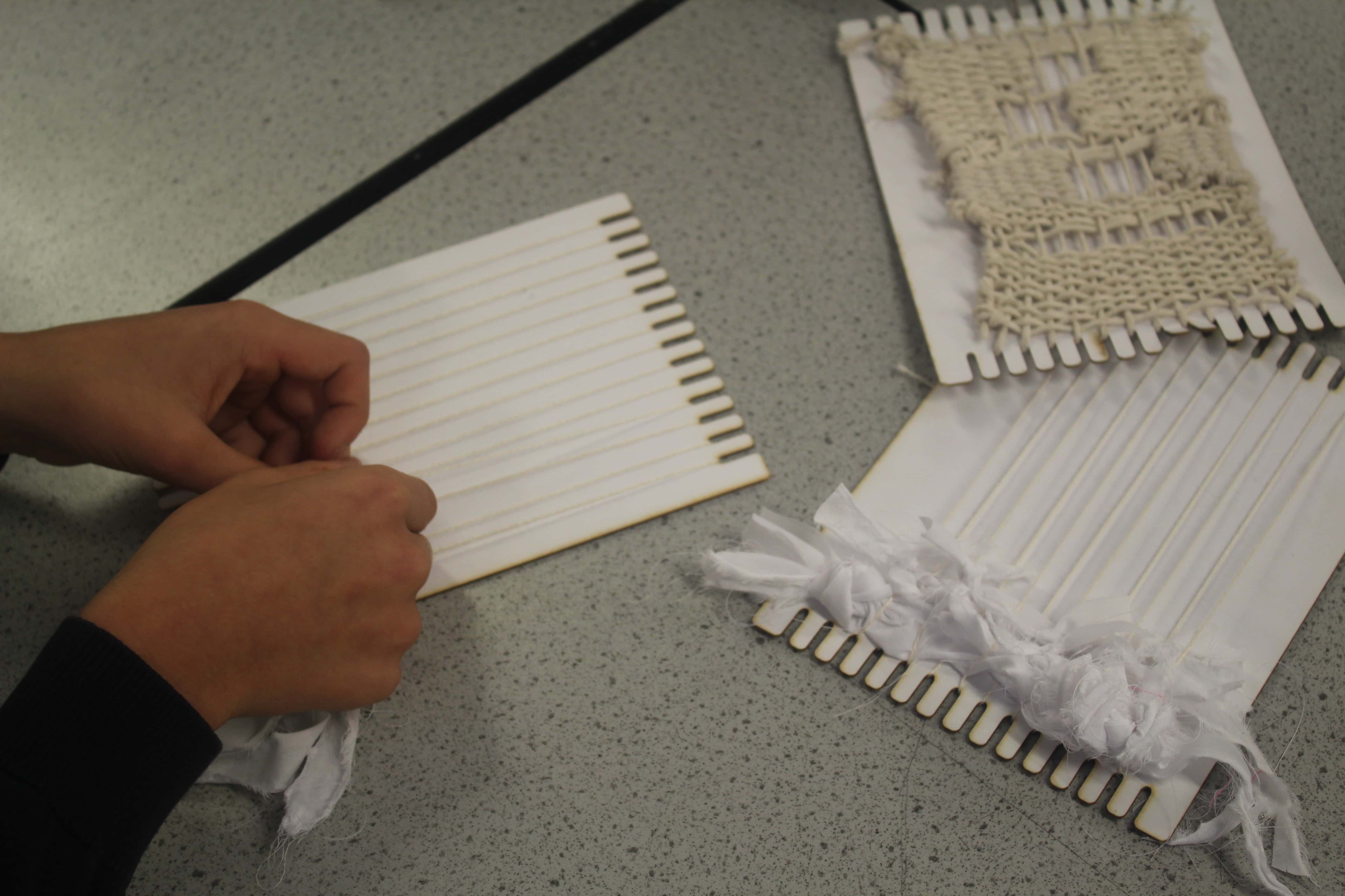A student from Cheadle Hulme High School works on their woven fabric piece during a fabric manipulation workshop for the Big Draw 2023.