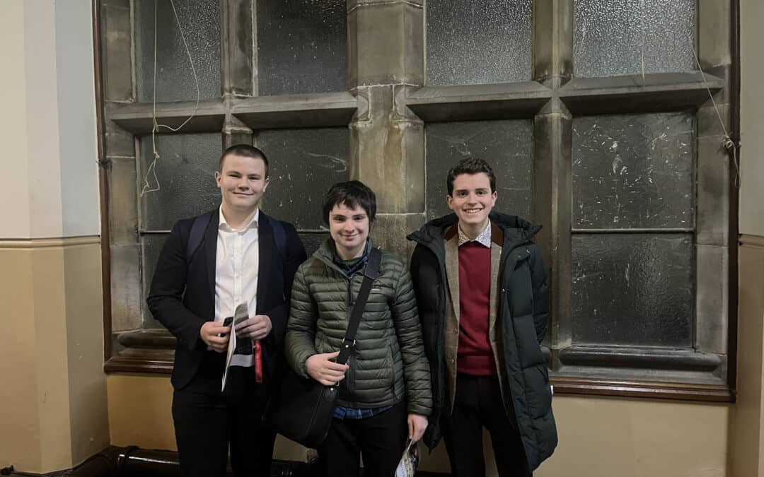 Three students from Cheadle Hulme High School and Sixth Form smile at the Stonyhurst Model United Nations conference 2024.