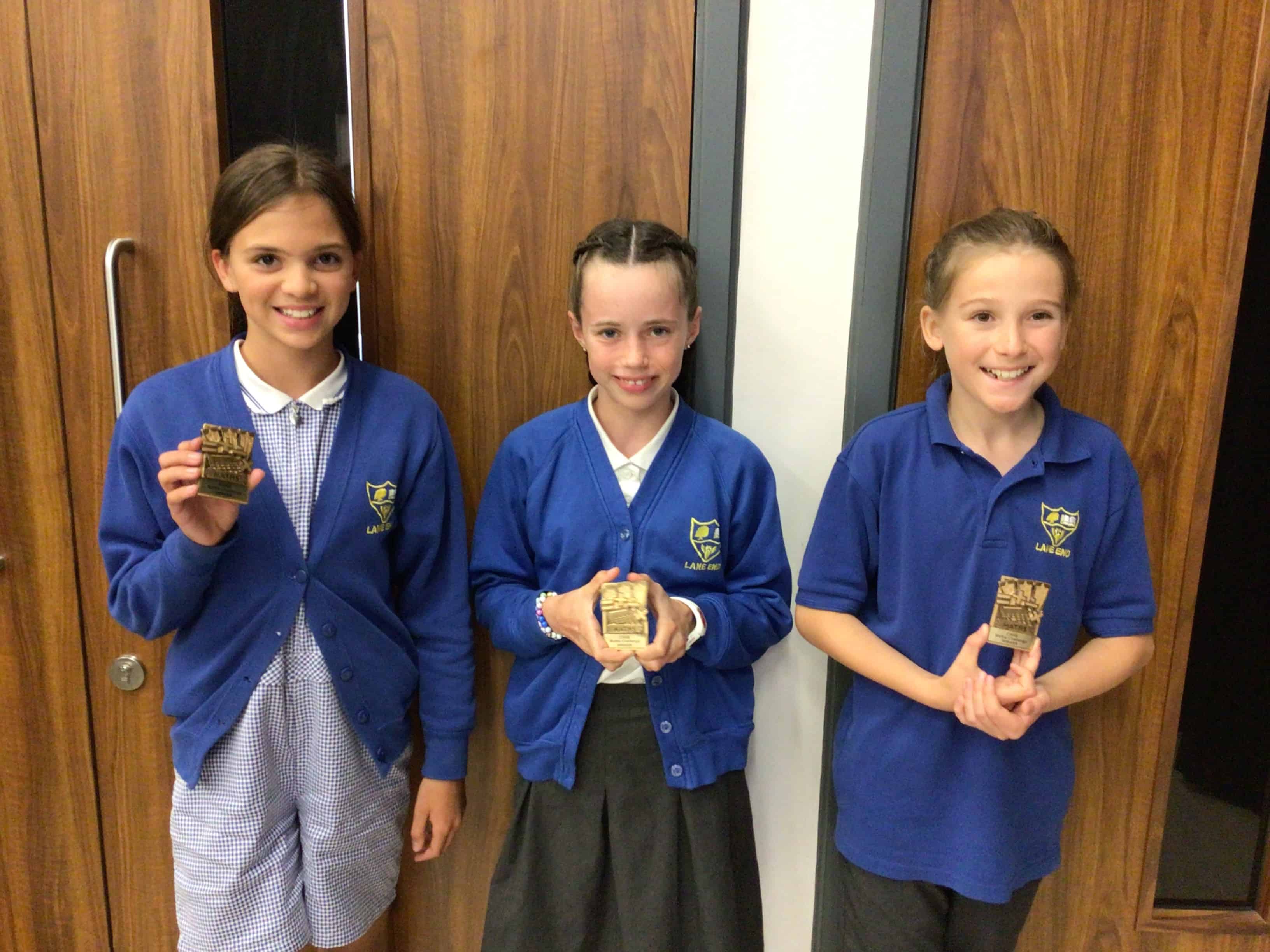 The winning pupils from Lane End Primary School smile with their CHHS Maths Award magnets that they earned at the Cheadle Hulme High School Maths Award Evening.