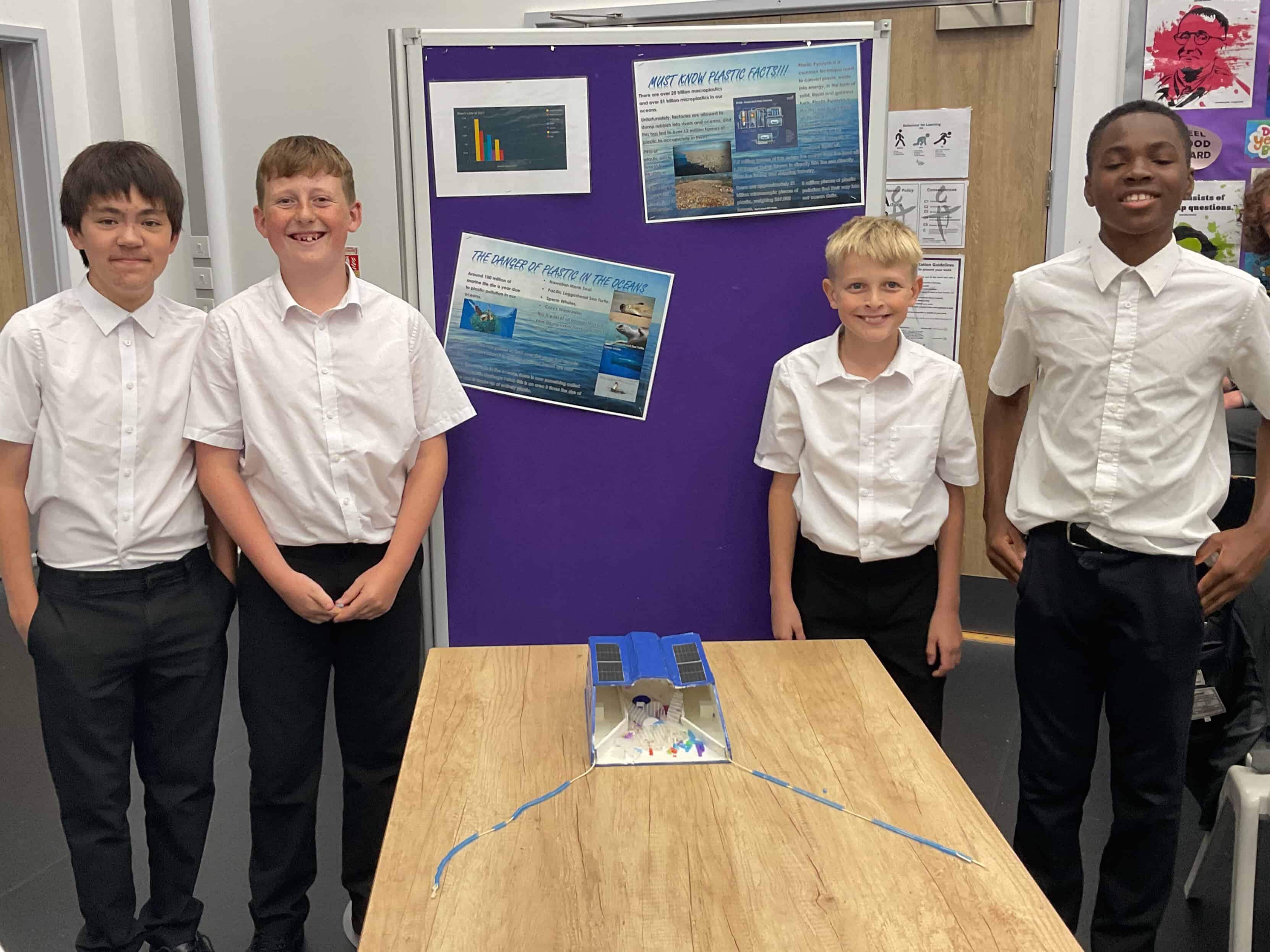 The four Cheadle Hulme High School students that make up Team AquaNet stand proudly next to their project at Laurus Cheadle Hulme.