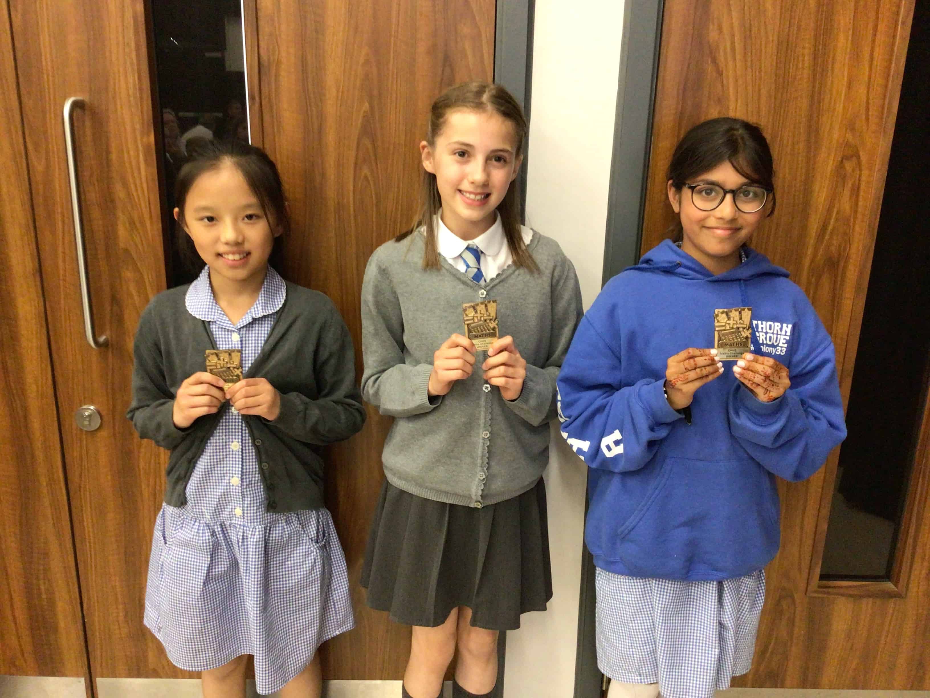 The winning pupils from Thorn Grove Primary School smile with their CHHS Maths Award magnets that they earned at the Cheadle Hulme High School Maths Award Evening.